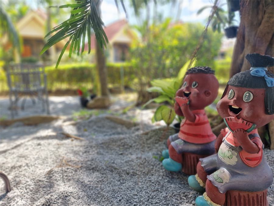 Two carved wooden figures in the garden