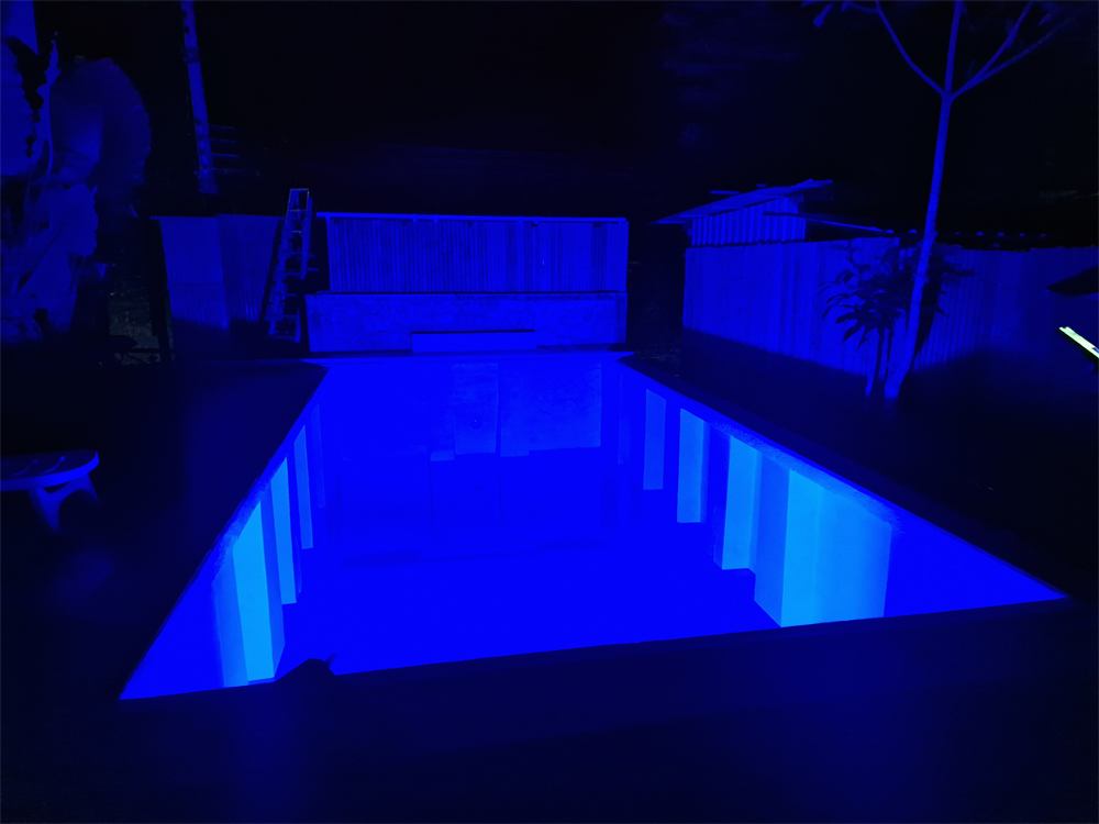 The pool lit blue at night